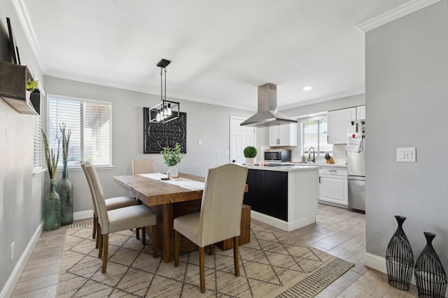 1583 San Gabriel Ave, Clovis, CA 93611 - dining room with crown molding, a chandelier, baseboards, light wood-style floors, and recessed lighting