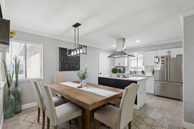1583 San Gabriel Ave, Clovis, CA 93611 - dining area with light wood finished floors, crown molding, recessed lighting, baseboards, and a chandelier
