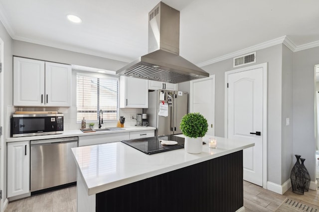 1583 San Gabriel Ave, Clovis, CA 93611 - kitchen with appliances with stainless steel finishes, island exhaust hood, a sink, light wood-type flooring, and white cabinetry