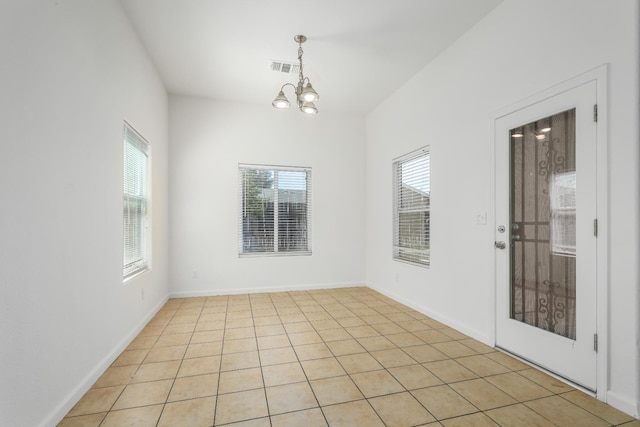 6674 E Alta Ave, Fresno, CA 93727 - spare room featuring a chandelier, light tile patterned floors, and baseboards