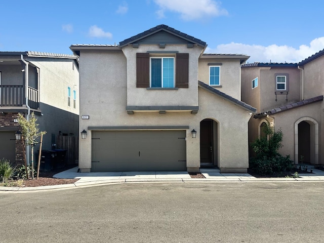 922 Winchell Way W, Madera, CA 93636 - view of front facade with stucco siding, a tile roof, and an attached garage