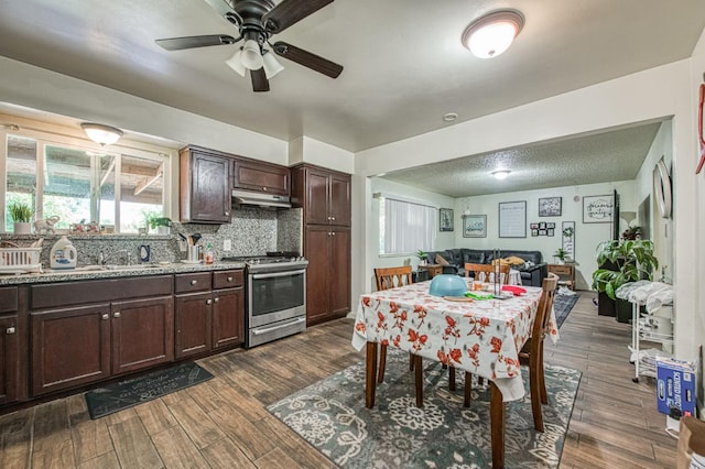 1431 N Willow Ave, Fresno, CA 93727 - kitchen with stainless steel gas stove, dark brown cabinets, a ceiling fan, and dark wood finished floors