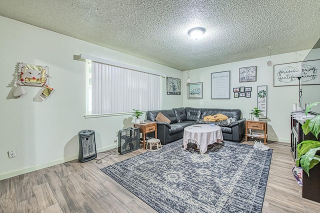 1431 N Willow Ave, Fresno, CA 93727 - living room featuring a textured ceiling, wood finished floors, and baseboards