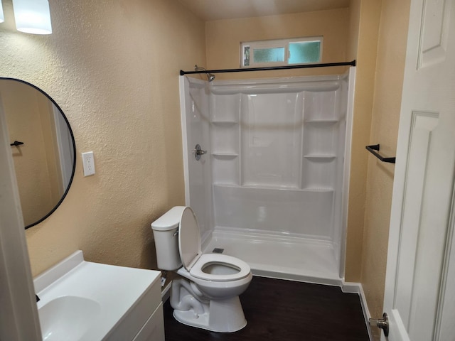 1132 E Fountain Way, Fresno, CA 93704 - bathroom with a textured wall, a shower, vanity, and toilet