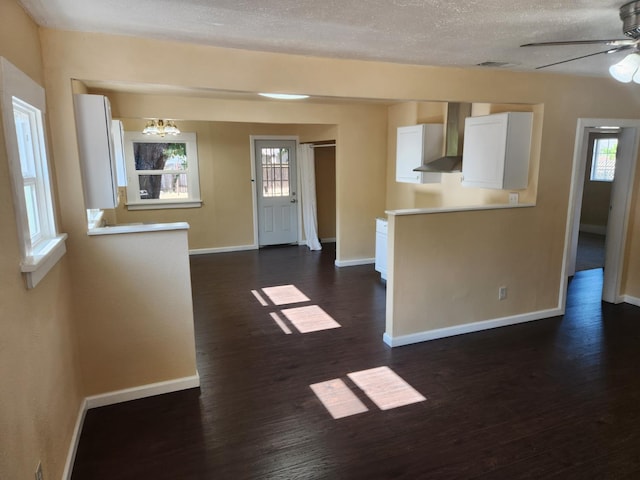 1132 E Fountain Way, Fresno, CA 93704 - unfurnished living room featuring baseboards, ceiling fan, dark wood-style flooring, a chandelier, and a textured ceiling