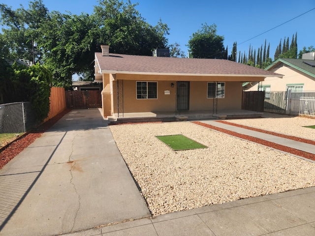 1132 E Fountain Way, Fresno, CA 93704 - single story home with a porch, concrete driveway, stucco siding, and a shingled roof