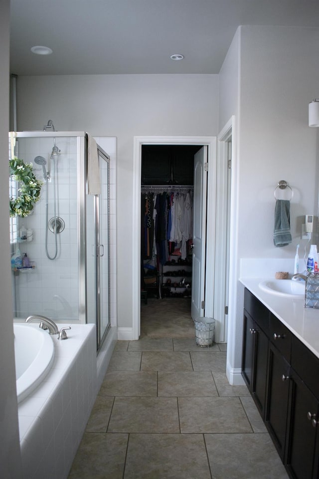 6379 W Northdale Ave, Fresno, CA 93723 - bathroom featuring a stall shower, a garden tub, vanity, a walk in closet, and tile patterned floors