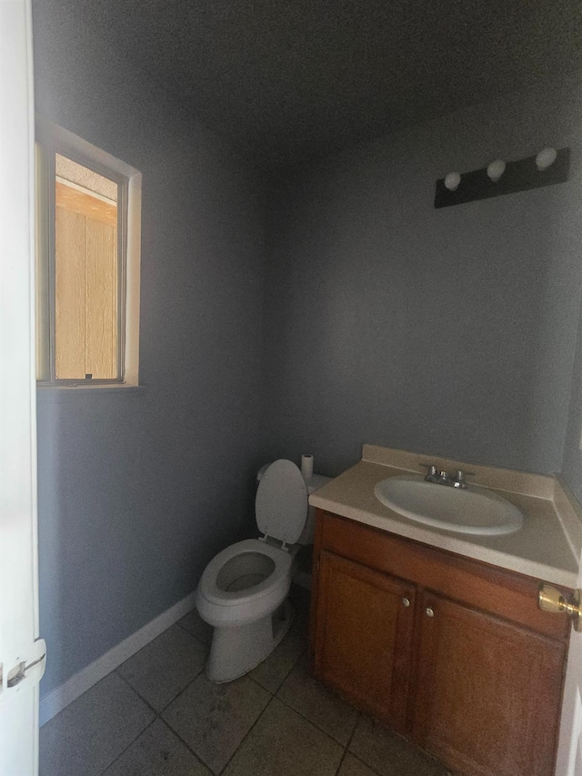 924 W Myers, Fresno, CA 93706 - half bathroom featuring tile patterned floors, toilet, vanity, and baseboards