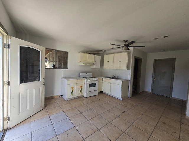 924 W Myers, Fresno, CA 93706 - kitchen with white gas stove, a sink, light countertops, light tile patterned flooring, and a ceiling fan