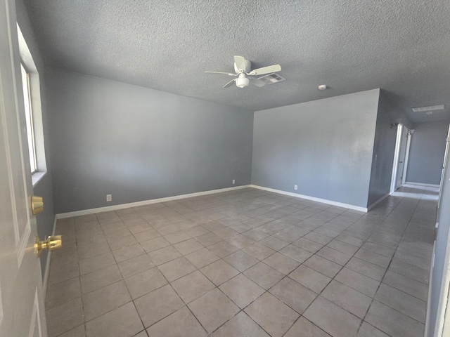 924 W Myers, Fresno, CA 93706 - tiled empty room with ceiling fan, a textured ceiling, and baseboards