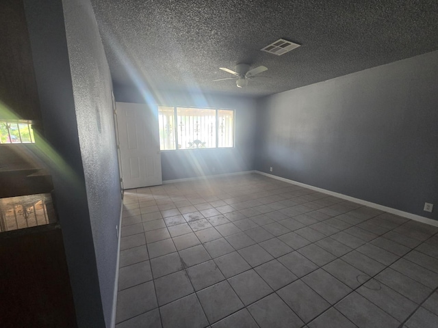 924 W Myers, Fresno, CA 93706 - spare room featuring ceiling fan, a textured ceiling, tile patterned floors, and baseboards