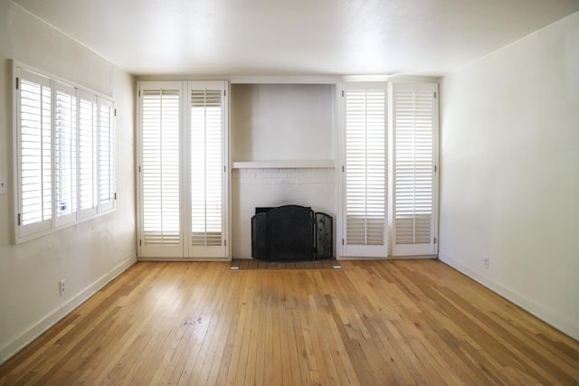 1020 E Saginaw Way, Fresno, CA 93704 - unfurnished living room with hardwood / wood-style floors, a fireplace, and plenty of natural light