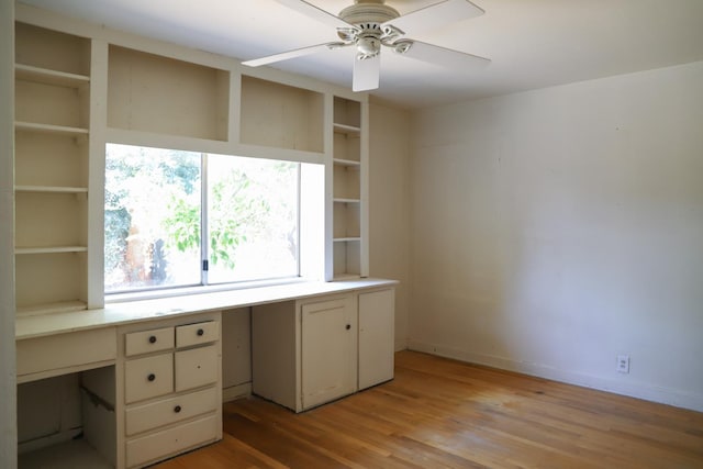1020 E Saginaw Way, Fresno, CA 93704 - unfurnished office featuring built in desk, ceiling fan, and light wood-type flooring