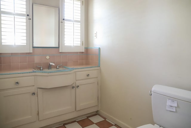 1020 E Saginaw Way, Fresno, CA 93704 - bathroom featuring vanity, decorative backsplash, plenty of natural light, and tile patterned floors