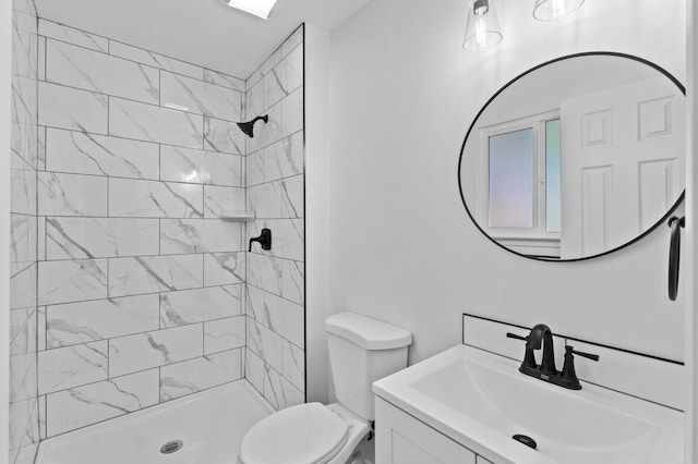 3877 N Ezie, Fresno, CA 93727 - full bathroom featuring toilet, a tile shower, and vanity
