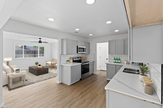 3877 N Ezie, Fresno, CA 93727 - kitchen with appliances with stainless steel finishes, gray cabinets, a ceiling fan, light wood-style flooring, and recessed lighting