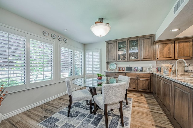 6772 N Wembley Dr, Fresno, CA 93711 - dining area featuring healthy amount of natural light, light wood-type flooring, and baseboards