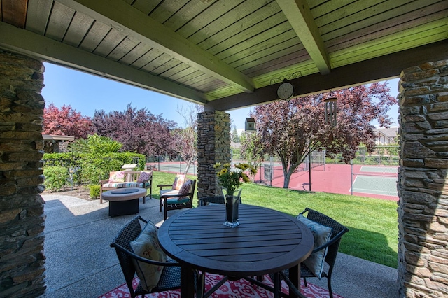 6772 N Wembley Dr, Fresno, CA 93711 - view of patio / terrace with an outdoor fire pit and a tennis court