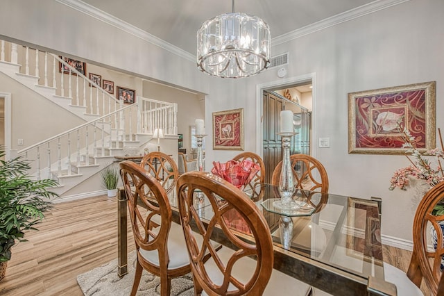 6772 N Wembley Dr, Fresno, CA 93711 - dining area featuring wood finished floors, crown molding, a chandelier, stairs, and baseboards