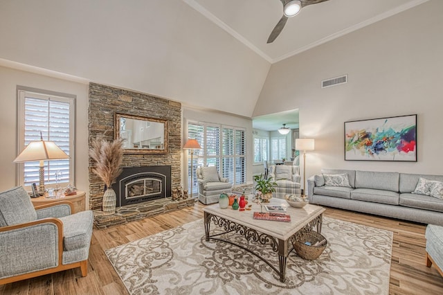 6772 N Wembley Dr, Fresno, CA 93711 - living room featuring ceiling fan, high vaulted ceiling, a fireplace, ornamental molding, and wood finished floors