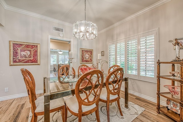 6772 N Wembley Dr, Fresno, CA 93711 - dining space featuring ornamental molding, a chandelier, wood finished floors, and baseboards