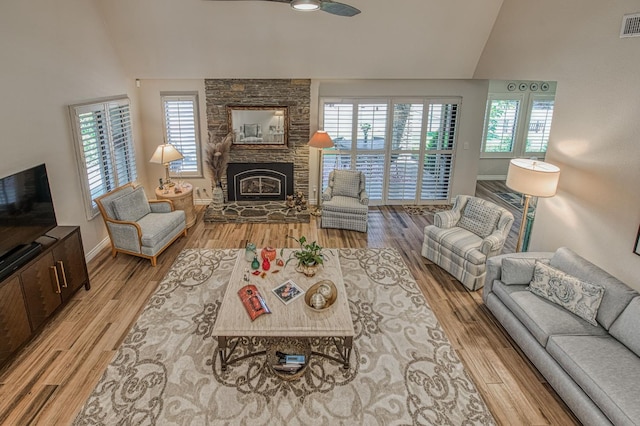 6772 N Wembley Dr, Fresno, CA 93711 - living room with lofted ceiling, ceiling fan, light wood-type flooring, baseboards, and a fireplace