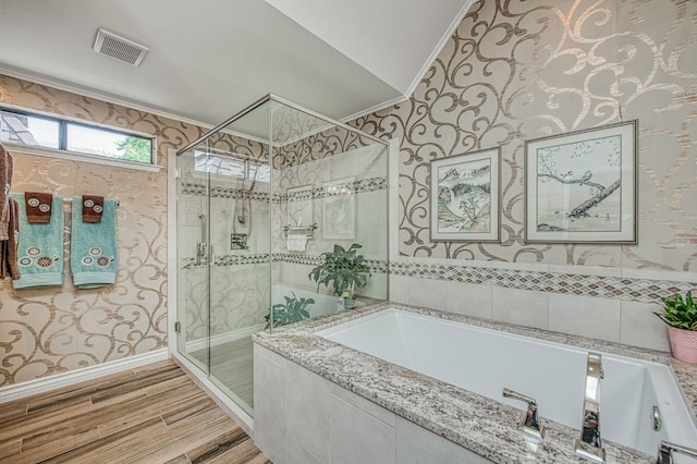 6772 N Wembley Dr, Fresno, CA 93711 - full bathroom with a garden tub, a shower stall, wallpapered walls, wood finished floors, and crown molding