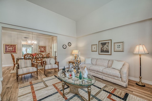 6772 N Wembley Dr, Fresno, CA 93711 - living room featuring baseboards, a chandelier, wood finished floors, and a towering ceiling