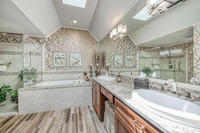 6772 N Wembley Dr, Fresno, CA 93711 - bathroom with a skylight, lofted ceiling, a bath, wood finished floors, and double vanity