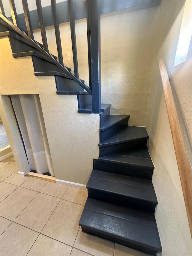 3023 E White Ave, Fresno, CA 93701 - stairway featuring tile patterned floors, a textured wall, and baseboards