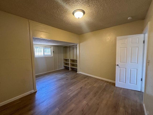 3023 E White Ave, Fresno, CA 93701 - unfurnished bedroom featuring wood finished floors, a textured ceiling, and baseboards