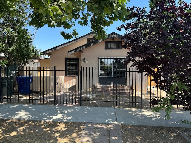 3023 E White Ave, Fresno, CA 93701 - view of front facade featuring stucco siding and a fenced front yard