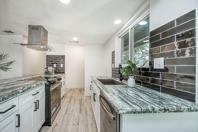 17367 Camden Dr, Madera, CA 93638 - kitchen with island exhaust hood, dishwasher, a sink, electric range oven, and tasteful backsplash