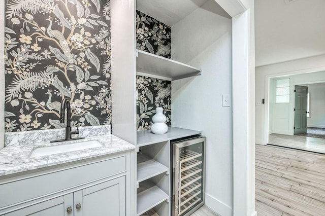17367 Camden Dr, Madera, CA 93638 - bar area with a sink, wine cooler, light wood-style floors, and baseboards