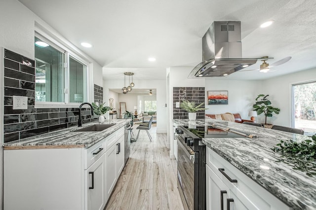 17367 Camden Dr, Madera, CA 93638 - kitchen featuring a sink, electric stove, ceiling fan, island range hood, and tasteful backsplash