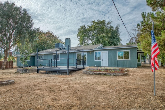 17367 Camden Dr, Madera, CA 93638 - rear view of house with a wooden deck, a chimney, and cooling unit