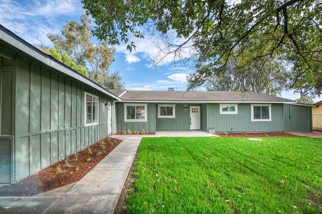 17367 Camden Dr, Madera, CA 93638 - view of front facade with board and batten siding, a front lawn, and a patio