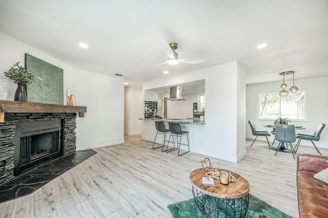 17367 Camden Dr, Madera, CA 93638 - living area featuring wood finished floors, baseboards, a fireplace, recessed lighting, and ceiling fan