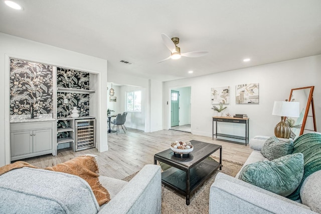 17367 Camden Dr, Madera, CA 93638 - living room with wine cooler, recessed lighting, a ceiling fan, and light wood-style flooring