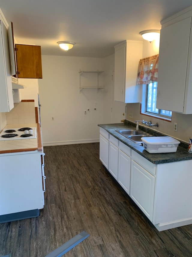 3127 E Mckenzie, Fresno, CA 93702 - kitchen with a sink, dark wood finished floors, white electric stovetop, white cabinetry, and decorative backsplash