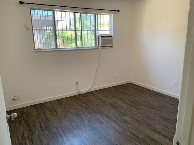 3127 E Mckenzie, Fresno, CA 93702 - spare room featuring dark wood-style floors, baseboards, and cooling unit