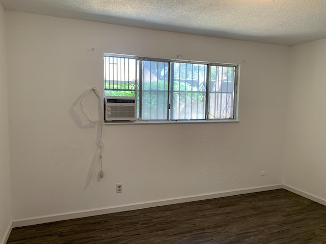 3127 E Mckenzie, Fresno, CA 93702 - spare room with plenty of natural light, dark wood-style flooring, a textured ceiling, and baseboards