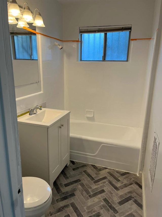 3127 E Mckenzie, Fresno, CA 93702 - bathroom featuring brick floors, vanity, toilet, shower / tub combination, and a chandelier