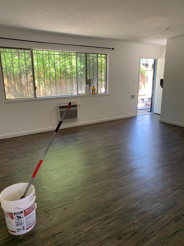3127 E Mckenzie, Fresno, CA 93702 - unfurnished living room with a textured ceiling, dark wood finished floors, and baseboards