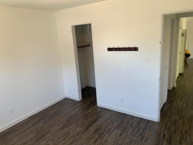 3127 E Mckenzie, Fresno, CA 93702 - unfurnished bedroom with dark wood-type flooring, a closet, baseboards, and a spacious closet
