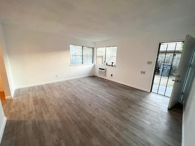 3127 E Mckenzie, Fresno, CA 93702 - unfurnished room with dark wood-style flooring, healthy amount of natural light, and baseboards