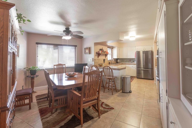1720 W Barstow Ave, Fresno, CA 93711 - dining area with light tile patterned floors, ceiling fan, a textured ceiling, and baseboards
