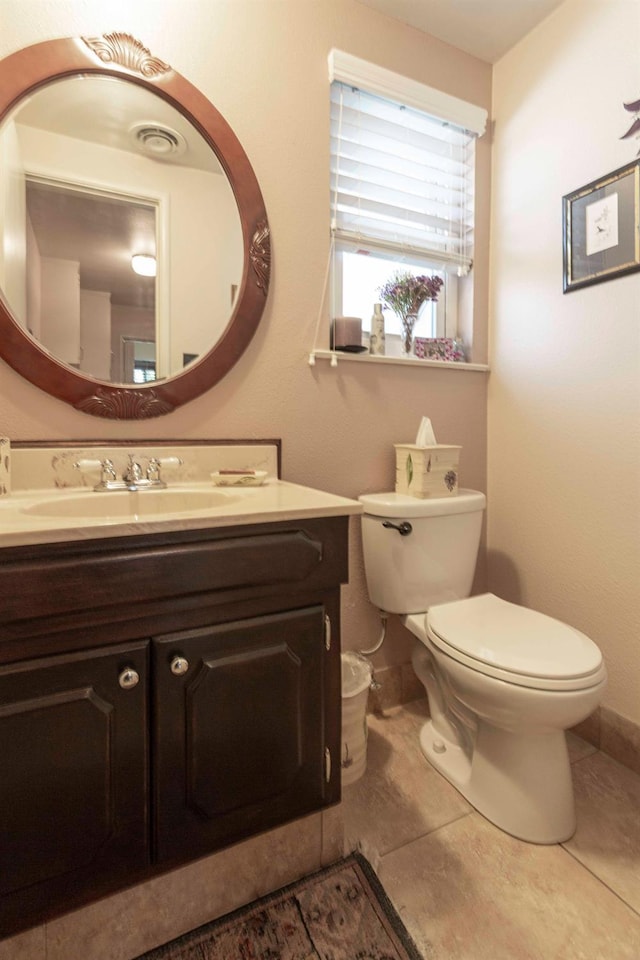 1720 W Barstow Ave, Fresno, CA 93711 - bathroom with vanity, toilet, baseboards, and tile patterned floors