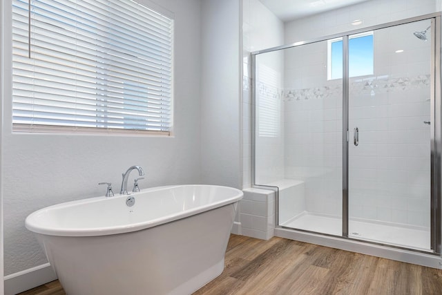 2054 N Laverne Ave, Fresno, CA 93727 - full bath featuring healthy amount of natural light, wood finished floors, a freestanding tub, and a shower stall