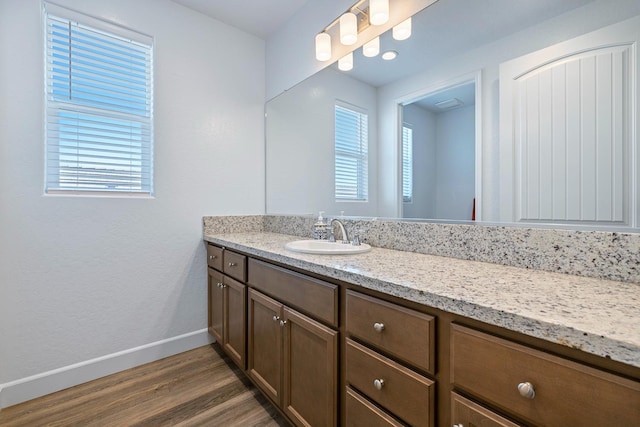 2054 N Laverne Ave, Fresno, CA 93727 - bathroom with vanity, wood finished floors, and baseboards
